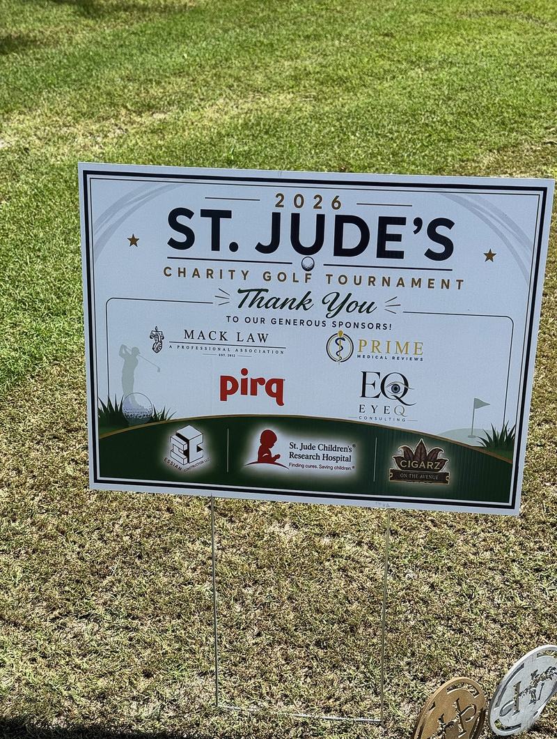 Sponsor sign at the 2026 St. Jude Charity Golf Tournament listing Mack Law P.A. among the sponsors
